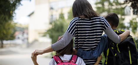 Mom walking kids to school.