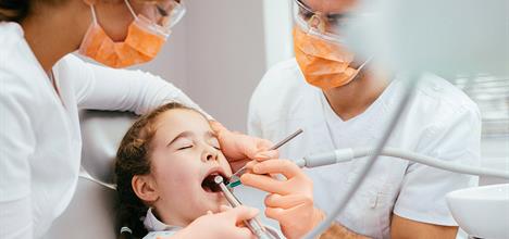 Girl in dentist chair.