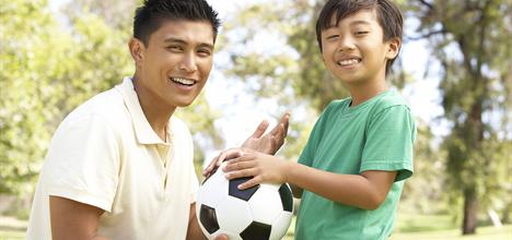 a man and a woman holding a football ball