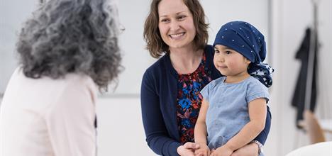 Mother with child talking to doctor.