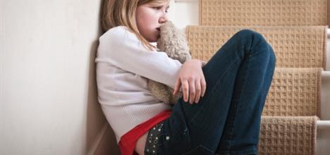 Young sad girl sitting at the stairs.