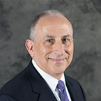 Paul Lipkin in a suit smiling