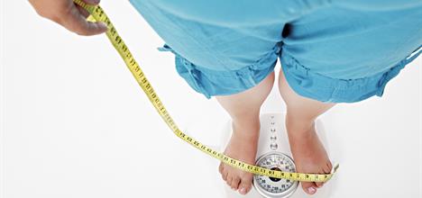 Child with obesity on a scale