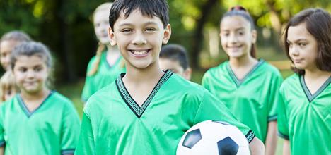 Preteen male soccer player with teammates