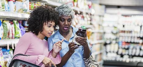 Women at the supermarket examining product labels