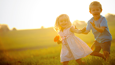 Kids playing at sunset.
