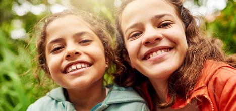 Two young girls smiling