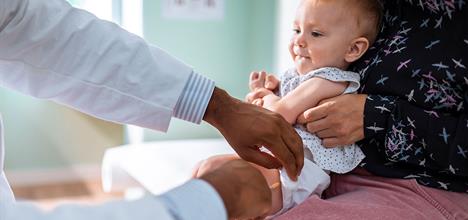 a baby being held by a doctor