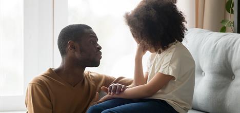 a person and a child sitting on a couch