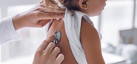 doctor checking child's breathing
