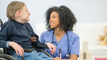 Nurse with boy in wheelchair.